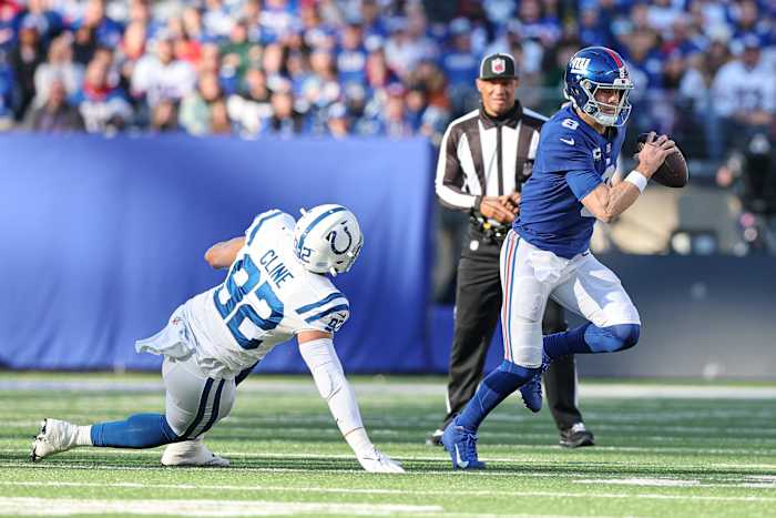 Jan 1, 2023; East Rutherford, New Jersey, USA; New York Giants quarterback Daniel Jones (8) scrambles as Indianapolis Colts defensive end Kameron Cline (92) pursues during the first half at MetLife Stadium.